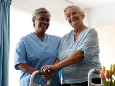 caregiver smiling with elderly woman